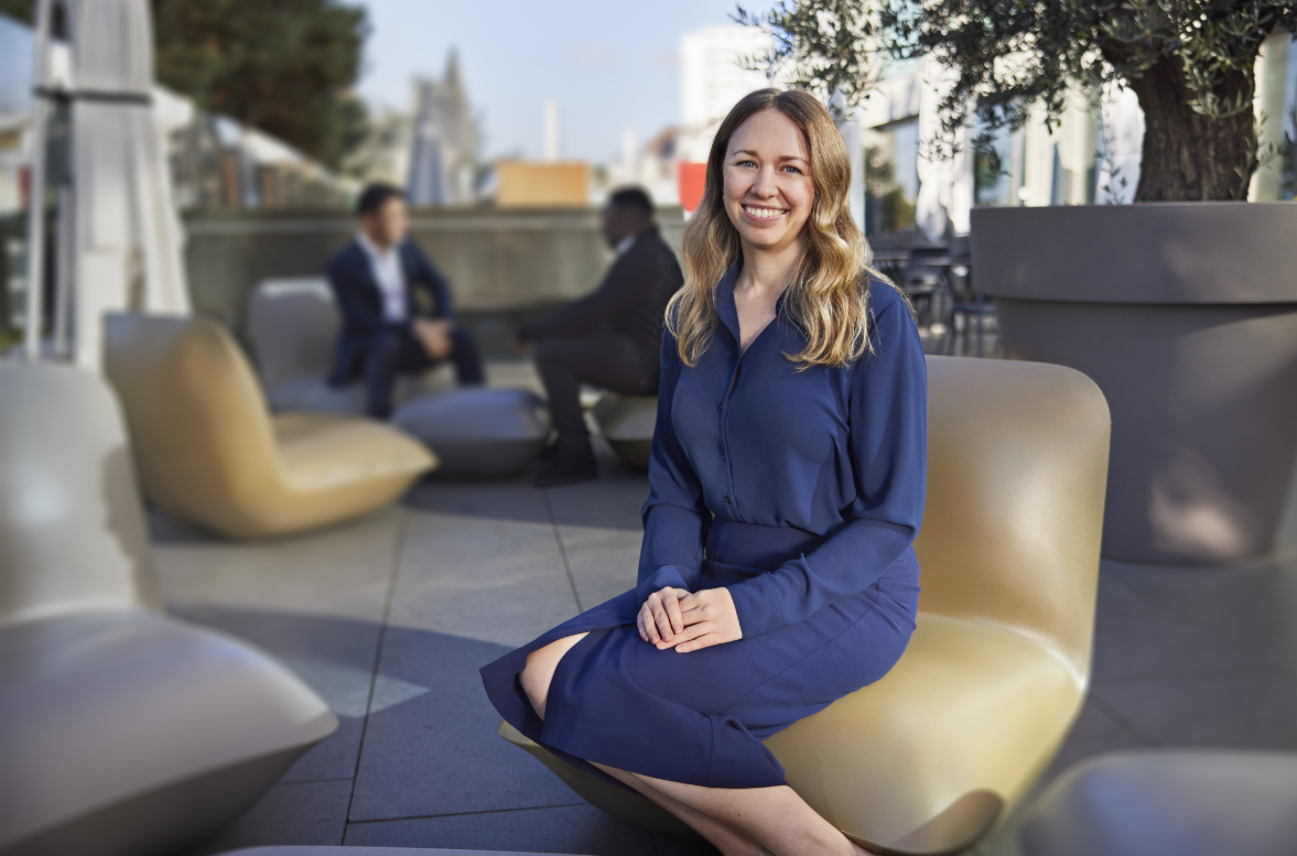 Team member seated outdoors